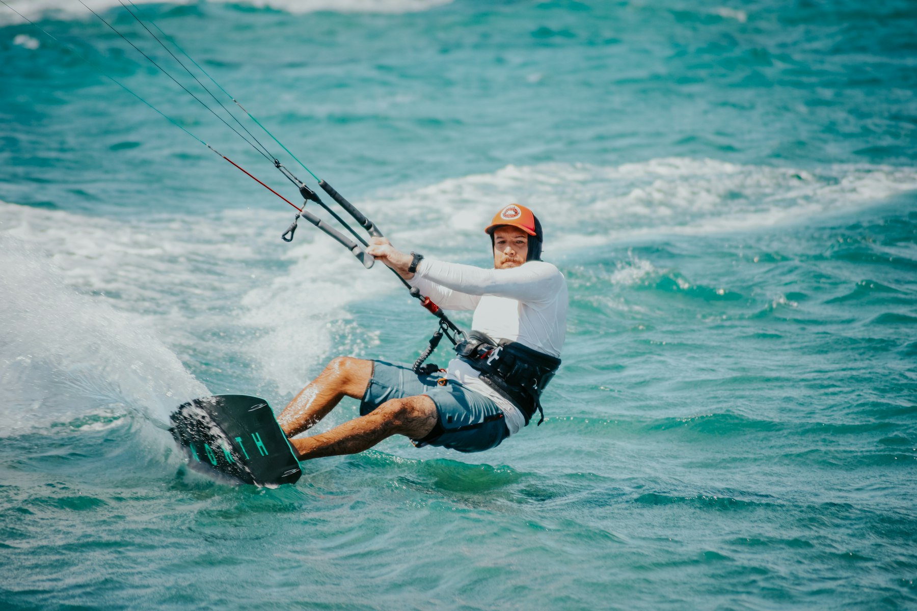 Kitesurfer launching a kite on the beach