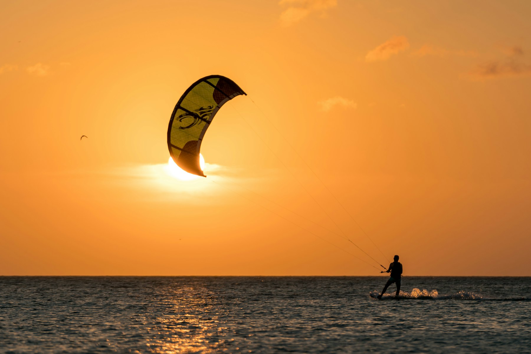 Kitesurfer at sunset over the ocean