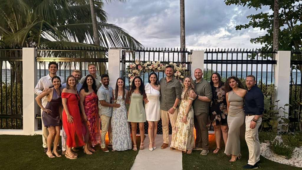 Wedding party celebrating in the oceanfront garden at Villa Azure Hotel