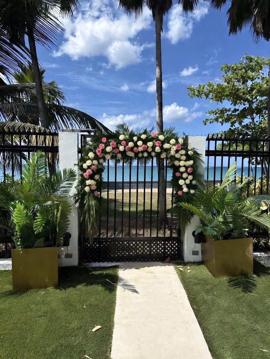 Wedding ceremony arch set up in the oceanfront garden at Villa Azure Hotel